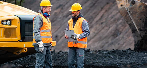 Two men talking on construction site