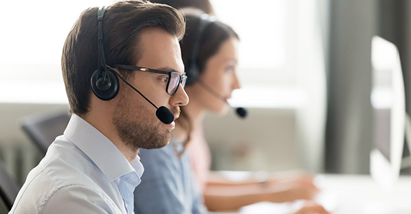 Two people conducting customer satisfaction survey over the phone