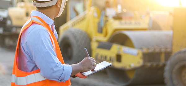 Man inspecting equipment on a jobsite