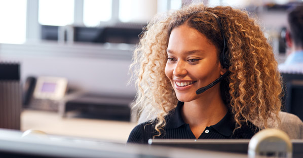 Woman conducting customer survey on the phone